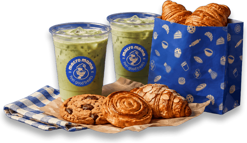 Two iced matchas beside cookies, a cinnamon swirl and croissants in a Macro Mama bag